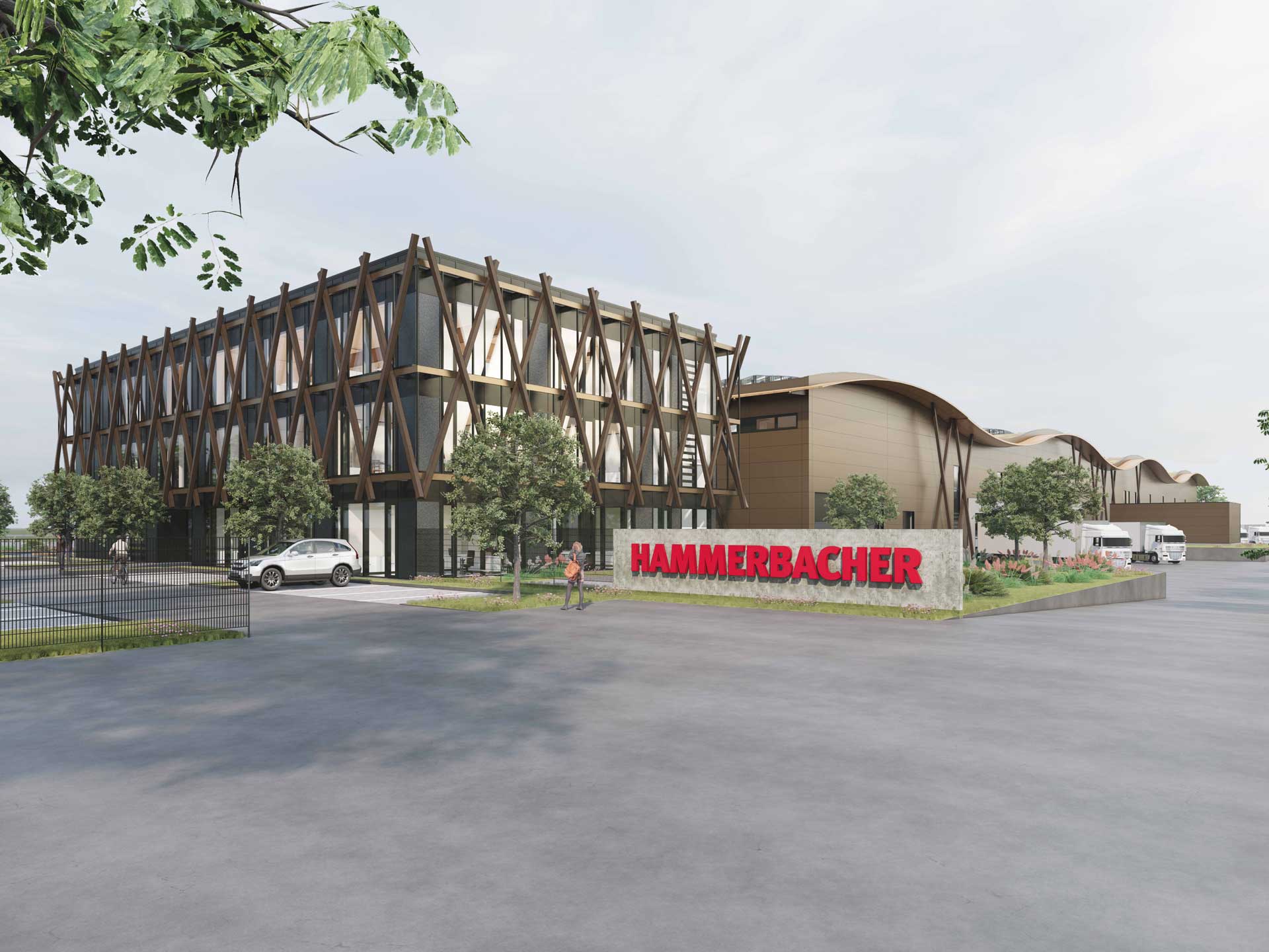 Außenansicht eines Verwaltungsgebäudes und einer Halle und ein Schild mit der Aufschrift Hammerbacher